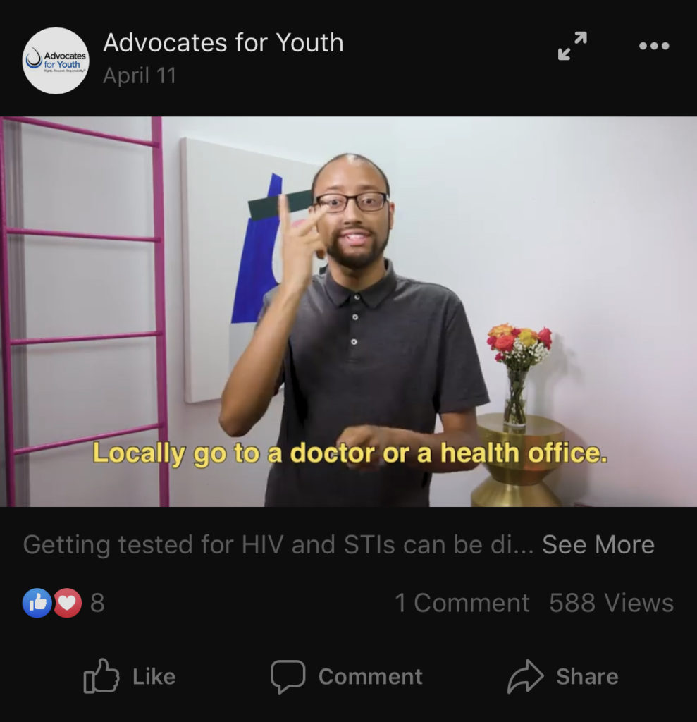 Image is screengrab of a video on Facebook of a brown-skinned person wearing glasses who is using sign language. Below the bottom third of the screen is an example of how Captioning can use text to share what the person in the video is signing, speaking, or hearing.
